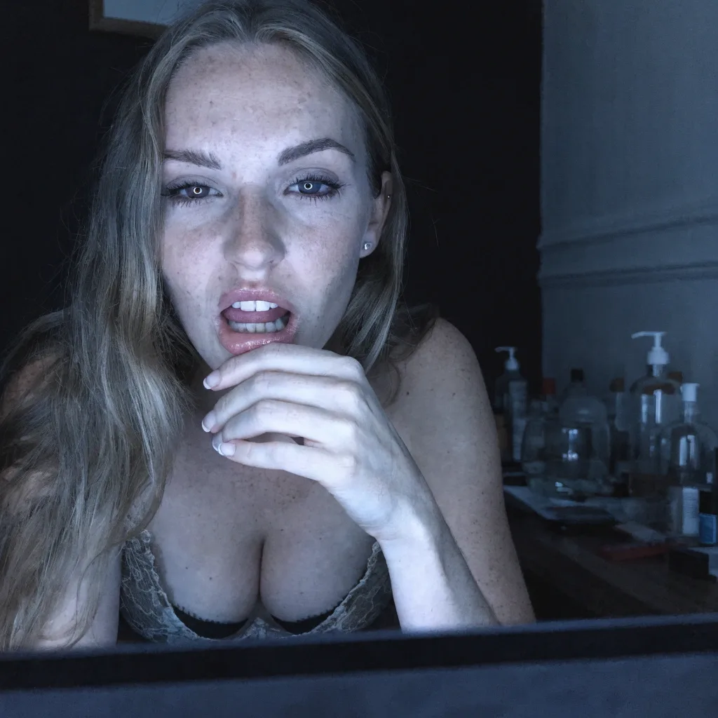woman watching her screen intently in the dark